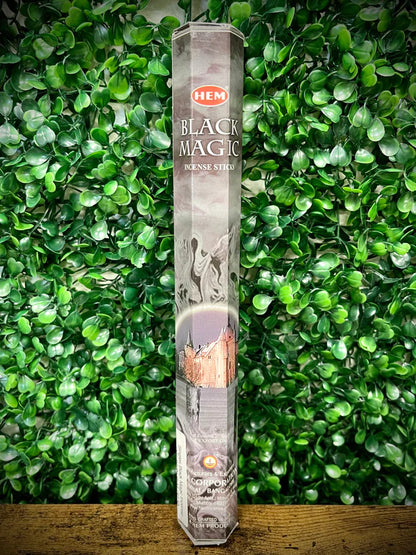 Hem Black Magic incense stick packaging on a green leafy background