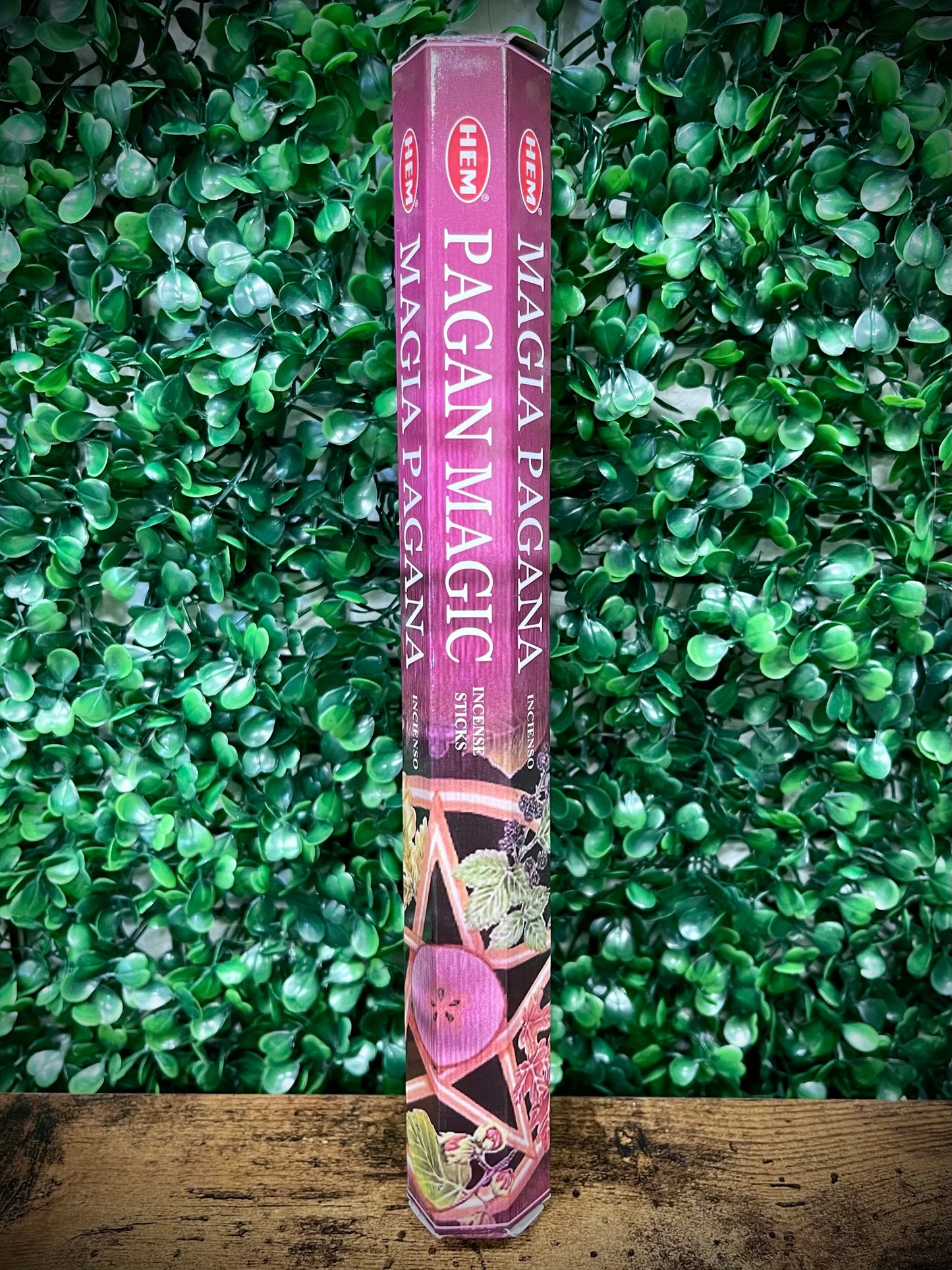 Hem Pagan Magic incense stick against a green leafy background