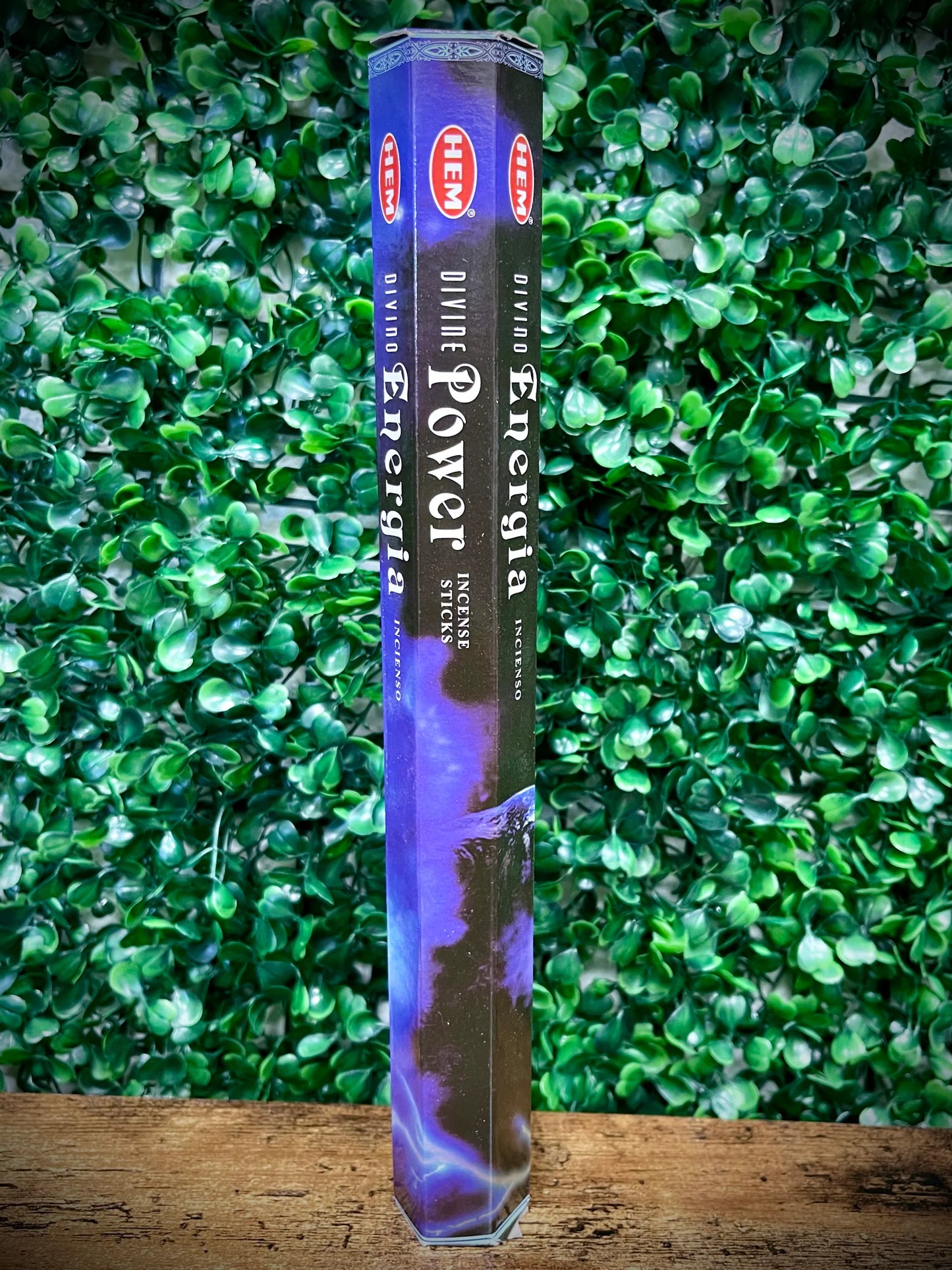 Hem Power Energy incense stick packaging against a green leafy background