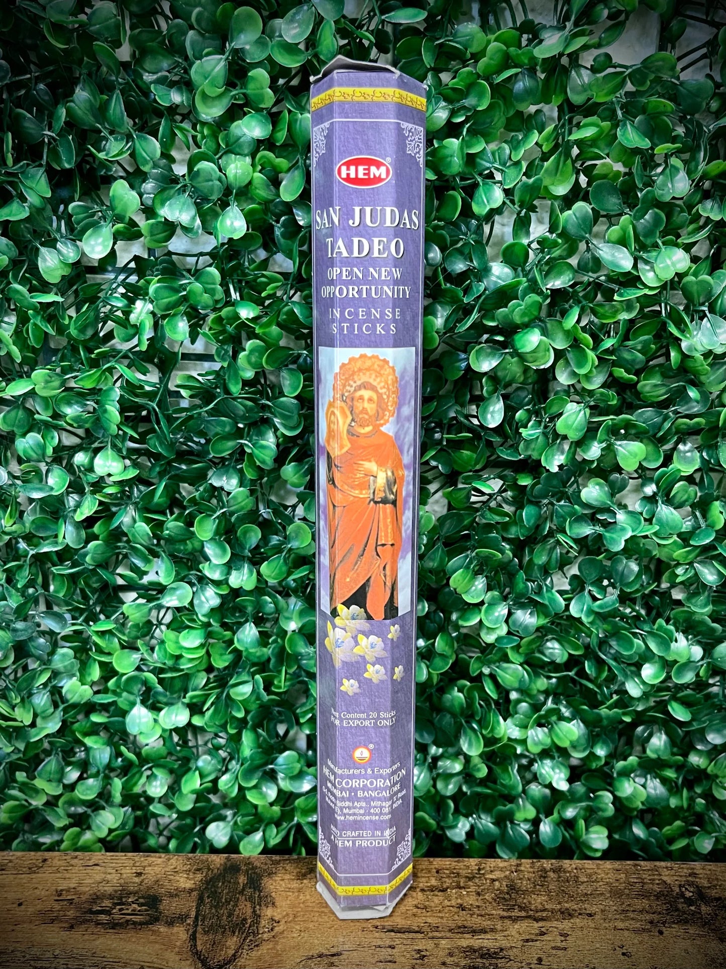 Hem incense stick packaging with a religious figure on a green leafy background