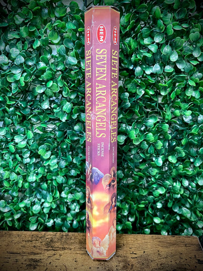 Hexagonal incense stick packaging with 'Seven Archangels' text against a green leafy background