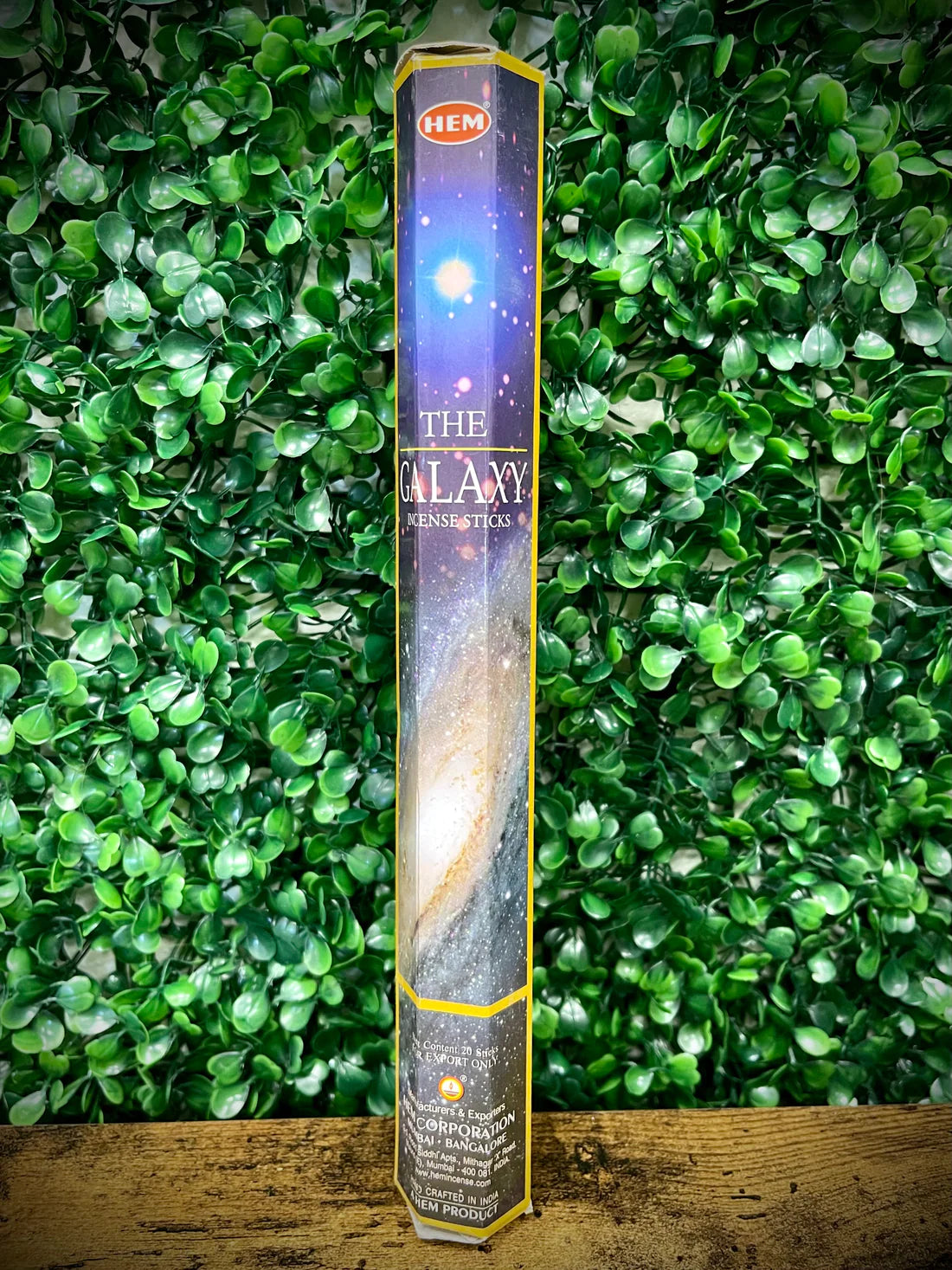 Hem incense stick packaging with a galaxy design against a green leafy background