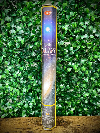 Hem incense stick packaging with a galaxy design against a green leafy background